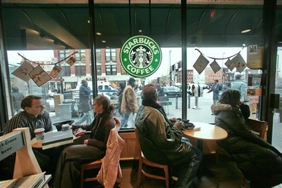 Patrons sit inside a Starbuck's in the New York neighborhood of Harlem on Monday Dec. 10, 2007.  Increasingly, Harlem's commercial and cultural backbone, 125th Street, has seen many of its black-owned businesses forced out by high rents and replaced by branches of national chain brands like Starbucks. Harlem is the historic capital of black American culture, but like many New York neighborhoods, it is rapidly changing and old-timers worry that redevelopment will wipe out mom-and-pop stores and affordable housing, along with the area's distinct character. (AP Photo/Bebeto Matthews)