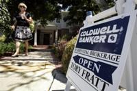 AP - FILE - In this June 23, 2009 file photo, a woman tours a home for sale in Menlo ...