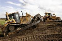 AP - FILE - In this March 19, 2008 file photo, a pair of Caterpillar D6 bulldozers work on construction ...