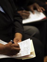 AP - In this Oct. 13, 2009 photo, job seekers fill in employment application forms at a career fair in ...