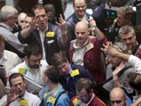 AP - Oil traders work in the options pit on the floor of the New York Mercantile Exchange Wednesday, Oct. ...