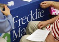 Reuters - A couple listens as a representative from Freddie Mac talks to them about a loan modification for their ...