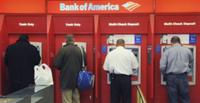 AP - FILE - In this Oct. 16, 2009 file photo, customers use ATMs at a Bank of America branch ...