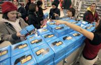 AP - FILE - In this Friday, Nov. 27, 2009 file photo, shoppers look at TomTom GPS devices at a ...
