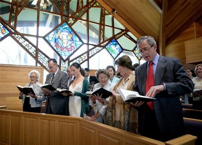 In this file photo originally provided by the White House, President Bush and first lady Laura Bush participate in an Easter service at the Evergreen Chapel in Camp David, Md., April 16, 2006. Also pictured in the front row, from right, are: Jenna Welch, mother of the first lady, Barbara Bush, former President George H. W. Bush and former first lady Barbara Bush. (AP Photo/White House Photo, Eric Draper)