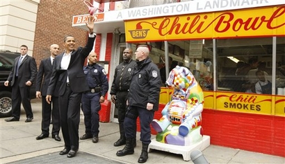 In this file photo, President-elect Barack Obama waves to onlookers as he leaves Ben's Chili Bowl where he stopped to eat with Washington Mayor Adrian Fenty in Washington, Jan. 10, 2009. (AP Photo/Gerald Herbert)