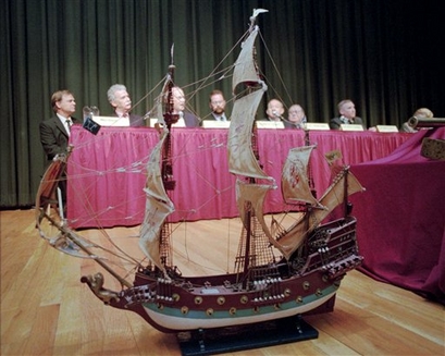 In this Monday, March 3, 1997 file picture, a replica of the ship 'Queen Anne's Revenge' rests on a stage in Raleigh, N.C. in front of the scientists and researchers who helped discover what is believed to be Blackbeard's flagship in the waters off of the North Carolina coast. An anchor from the shipwreck is so unstable that divers in North Carolina went ahead and retrieved it immediately on Wednesday, Oct. 21, 2009 rather than waiting until next year. (AP Photo/Karen Tam)