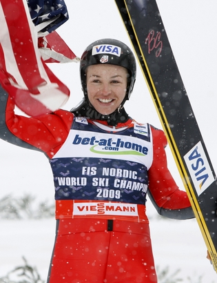 United States' gold medal winner Lindsey Van celebrates with the American flag after the Women's Normal Hill Individual final at the Ski Jumping competitions of the Nordic World Ski Championships in Liberec, Czech Republic, Friday, Feb. 20, 2009. (AP Photo/Matthias Schrader)