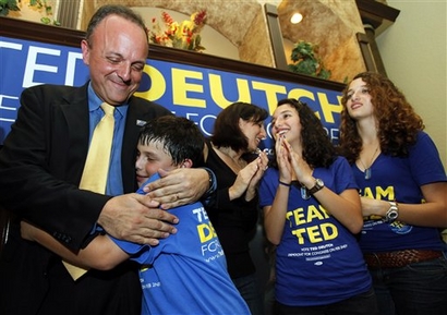 In this Feb. 2, 2010, photo, State Sen. Ted Deutch, D-Boca Raton, left, hugs his son Cole, 11, as his wife Jill, center, and daughters Gabby, 14, second from right, and Serena, 14, look on, after Deutch was nominated to be a candidate to replace former U.S. Rep. Robert Wexler during special primary election for District 19, which includes parts of Broward and Palm Beach counties, in Boca Raton, Fla. The winners of the special primary will meet in a special general election April 13. The victor will serve the last nine months of Wexler's term, then run for re-election to a full term in November. (AP Photo/Wilfredo Lee)