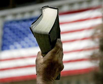 Frank Martinez holds his Bible in the air as he takes part in the National Day of Prayer at city hall in San Antonio, Texas, in this May 4, 2006 photo.  (AP Photo/Eric Gay)