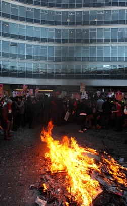 Students burn placards as they besiege Millbank ...