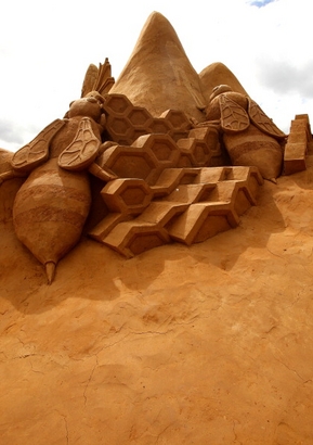 A sand sculpture called "The Hive" carved by ...
