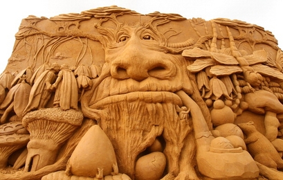A sand sculpture called "Enchanted Garden" carved ...