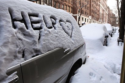 The word 'HELP' is written on the window of a car covered in snow on West 73rd Street on December 28, 2010 in New York City.  Two days after a blizzard pounded the city many of the city's streets remain unclear. (Photo by Andrew Burton/Getty Images)