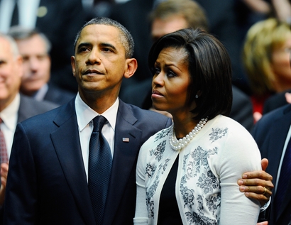 President Barack Obama (L) comforts his wife ...