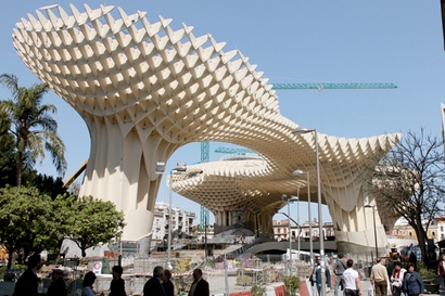 The wooden structure rises high above the ground, ...