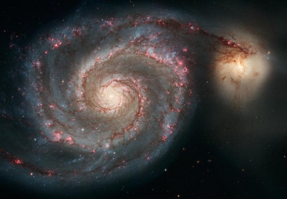 The large Whirlpool Galaxy (left) is known for ...