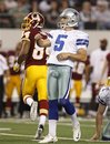 Dallas Cowboys kicker Dan Bailey (5) and Washington Redskins wide receiver Niles Paul , rear, look on at Bailey's winning field goal late in their NFL football game, Monday, Sept. 26, 2011, in Arlington, Texas. Bailey kicked six field goals in the 18-16 Cowboys win.