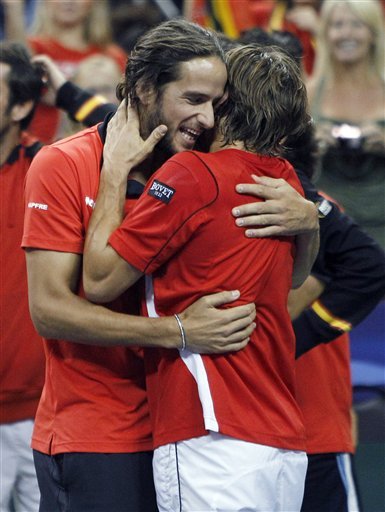 Spain's Feliciano Lopez, Left, Congratulates Teammate David Ferrer, Who Defeated Mardy Fish, Of The United States, 7-5,