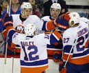 New York Islanders ' Josh Bailey , left, and Milan Jurcina , of Slovakia, celebrate their win with teammates following NHL hockey action against the Calgary Flames in Calgary, Canada, Monday, Jan. 3, 2011. The New York Islanders beat the Calgary Flames 5-2.