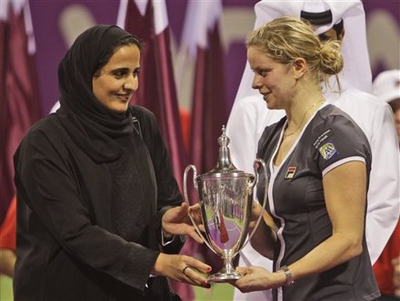 Belgium's Kim Clijsters, Right, Receives The Trophy From Sheikha Alayassa Bint Hamad Bin Khalifa Al Thani, Daughter Of