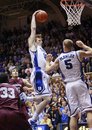 Duke's Kyle Singler brings down a rebound as Mason Plumlee (5) looks on with Colgate's Yaw Gyawu (33) and John Brandenburg during the first half of an NCAA college basketball game in Durham, N.C., Friday, Nov. 19, 2010. Duke won 110-58.