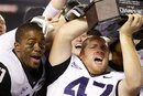 TCU 's Anson Kelton , right, celebrates with the winner's trophy after TCU defeated Louisiana Tech 31-24 in the Poinsettia Bowl NCAA college football game Wednesday, Dec. 21, 2011, in San Diego.