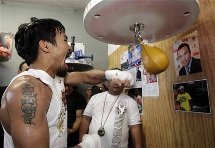 With A Photo Of Juan Manuel Marquez Posted On The Wall, Boxer Manny Pacquiao, Left, Of The Philippines, Hits A Speed
