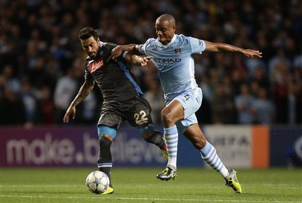 Manchester City's Vincent Kompany, Right, Fights