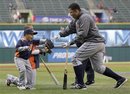 Detroit Tigers first baseman Miguel Cabrera , right, plays with Victor Martinez , rear left, son of Detroit Tigers' Victor Martinez, before the team faced the Cleveland Indians in a baseball game in Cleveland on Friday, April 29, 2011.