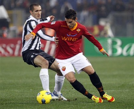 Juventus' Giorgio Chiellini, Left, And AS Roma's Erik Lamela Of Argentina Fight For The Ball