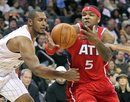 Charlotte Bobcats ' Boris Diaw (32) misses the steal as Atlanta Hawks ' Josh Smith (5) controls the ball in the second half of an NBA basketball game in Charlotte, N.C., Saturday, Jan. 22, 2011. The Hawks won 103-87.