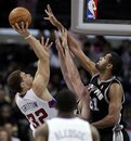 Los Angeles Clippers forward Blake Griffin , left, shoots against San Antonio Spurs center Tim Duncan , right, and Spurs' Matt Bonner during the first half of an NBA basketball game in Los Angeles, Wednesday, Dec. 1, 2010.