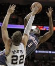 Charlotte Bobcats ' D.J. White , right, shoots over San Antonio Spurs ' Tiago Splitter , of Brazil, during the second half of an NBA basketball game, Saturday, March 19, 2011, in San Antonio. San Antonio won 109-98.