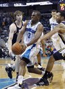 New Orleans Hornets point guard Chris Paul (3) drives to the basket between Utah Jazz small forward Gordon Hayward , left, and point guard Devin Harris in the second half of an NBA basketball game in New Orleans, Monday, April 11, 2011. the Jazz won 90-78.