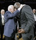 Charlotte Bobcats owner Michael Jordan, right, embraces former North Carolina coach Dean Smith, left, at halftime of an NBA basketball game between the Charlotte Bobcats and the Toronto Raptors in Charlotte, N.C., Tuesday, Dec. 14, 2010. Jordan was inducted into the North Carolina Sports Hall of Fame during a halftime ceremony. (AP Photo)