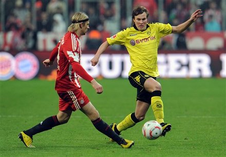 Munich's Anatoliy Tymoshchuk, Left, And Dortmund's Kevin Grosskreutz Challenge For The Ball