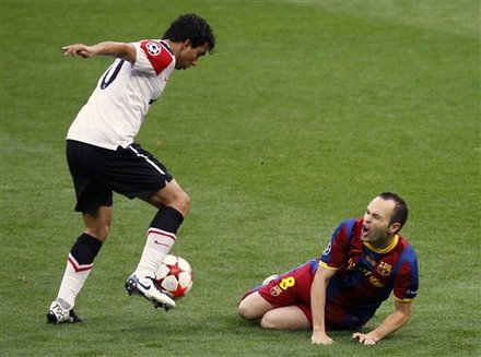 Manchester United's Fabio, Left, And Barcelona's Andres Iniesta In   Action