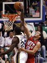 New Jersey Nets forward Kris Humphries (43) works to defend a shot by Utah Jazz forward Paul Millsap (24) during the first half of their NBA basketball game in Salt Lake City, Wednesday, Nov. 17, 2010.