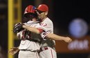 Philadelphia Phillies ' David Herndon , right, and Brian Schneider celebrate the 9-2 defeat of the San Francisco Giants at the end of a baseball game Friday, Aug. 5, 2011, in San Francisco.