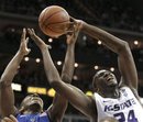 Duke guard Kyrie Irving, left, and Kansas State forward Curtis Kelly, right, rerach for a rebound during the first half of an NCAA college basketball game for the championship in the CBE Classic on Tuesday, Nov. 23, 2010, in Kansas City, Mo.