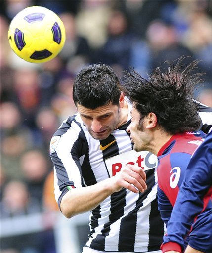 Juventus' Vincenzo Iaquinta, Left, And Genoa's Kakha Kaladze, Of Georgia, Jump For A Header