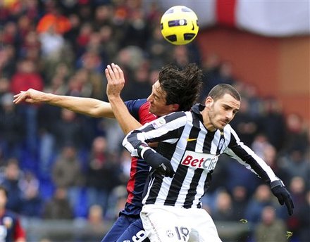 Juventus' Leonardo Bonucci, Right, And Genoa's Luca Toni Jump For A Header