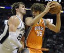 San Antonio Spurs center Tiago Splitter , left, of Brazil, defends Phoenix Suns center Robin Lopez during the first half of an NBA basketball game at the AT&T Center in San Antonio, Sunday, April 3, 2011.