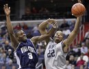 Georgetown's Julian Vaughn (22) reaches for a rebound as Utah State 's Brockeith Pane (3) defends during the first half of an NCAA college basketball game Saturday, Dec. 4, 2010, in Washington.