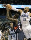 Orlando Magic 's Vince Carter (15) blocks a shot by Atlanta Hawks ' Marvin Williams during the first half of an NBA basketball game in Orlando, Fla., Monday, Dec. 6, 2010.