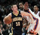 Indiana Pacers ' Tyler Hansbrough , left, drives around the New York Knicks defense during the second half of the NBA basketball game in New York, Sunday, March 13, 2011. The Pacers beat the Knicks 106-93. Hansbrough scored a career-high 29 points.