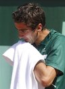 Croatia's Marin Cilic wipes his face as he plays Spain's Ruben Ramirez Hidalgo in their first round match of the French Open tennis tournament, at  the Roland Garros stadium in Paris, Sunday, May, 22, 2011.