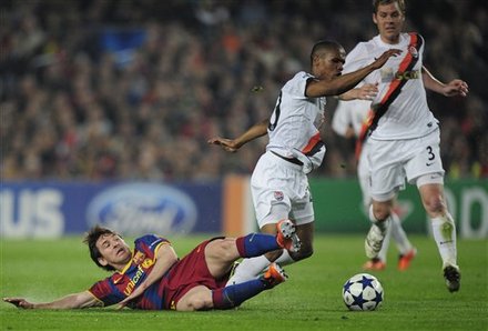 FC Barcelona's Lionel Messi From Argentina, Left, Duels For The Ball Against Shakhtar Donetsk's Brazilian Midfielder