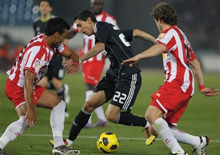 Real Madrid's Angel Di Maria From Argentina, Center, Duels For The Ball With Almeria's Marcelo Silva From Uruguay, Left,
